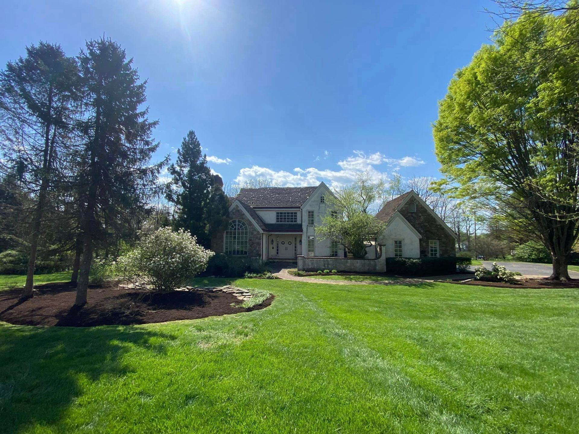 A large house with a large lawn in front of it
