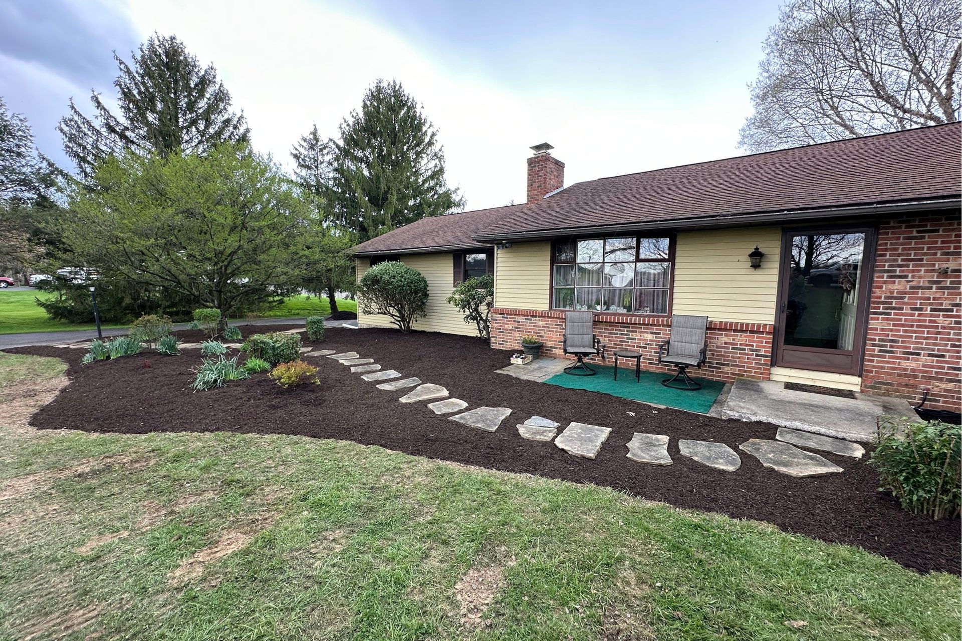 A group of people are walking down a dirt road next to a tractor.