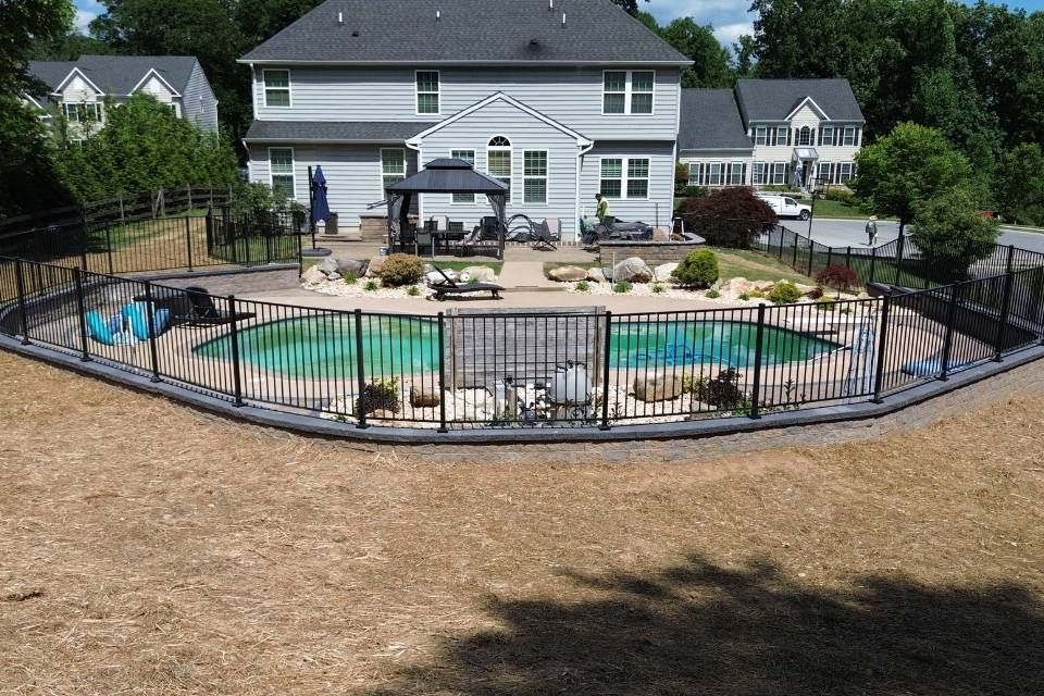 A large house with a large swimming pool in front of it