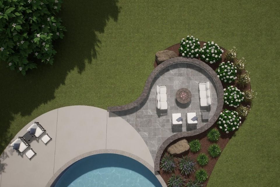 A wooden fence surrounds a garden with black mulch and gravel.