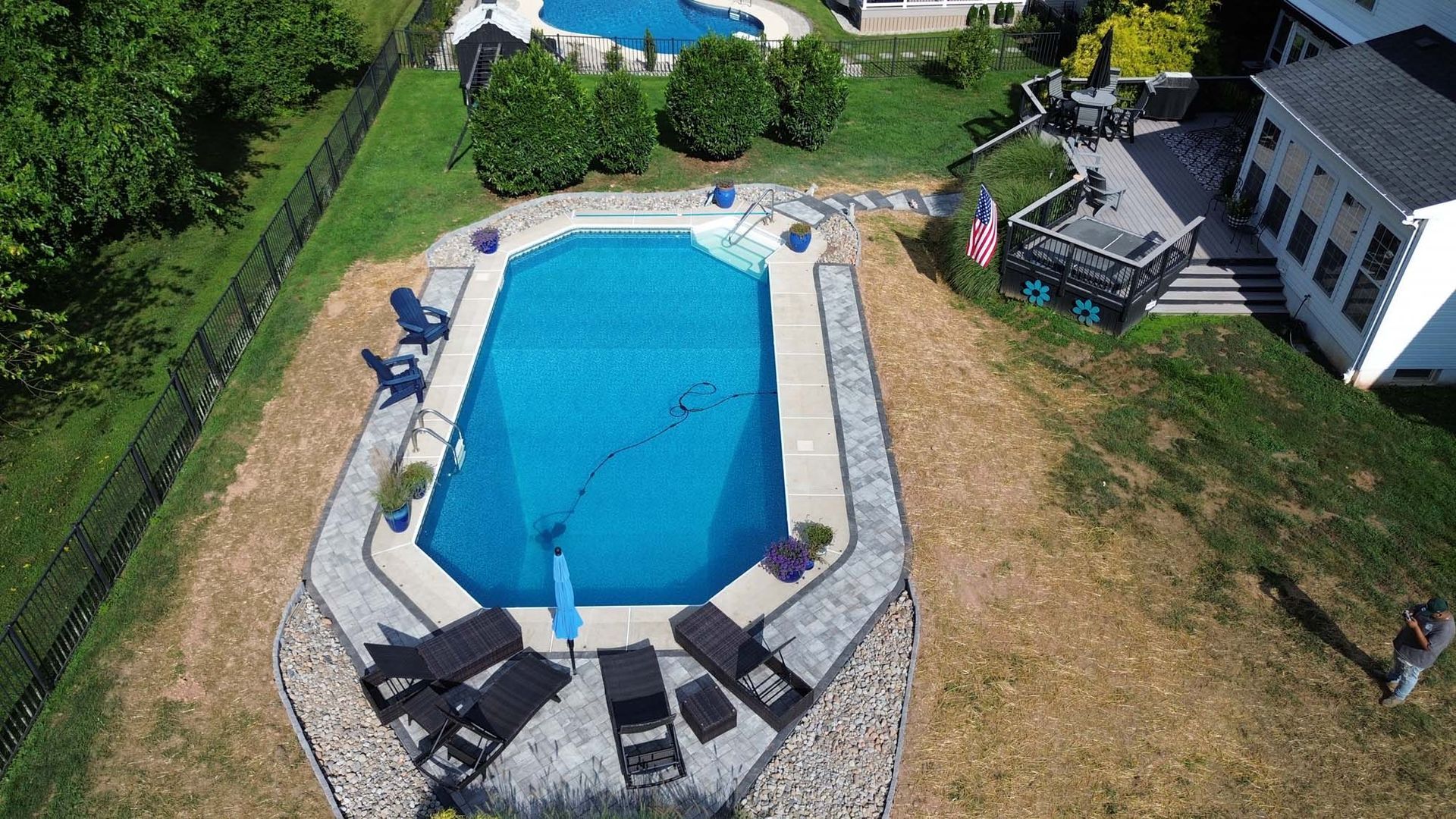 An aerial view of a swimming pool in a backyard.