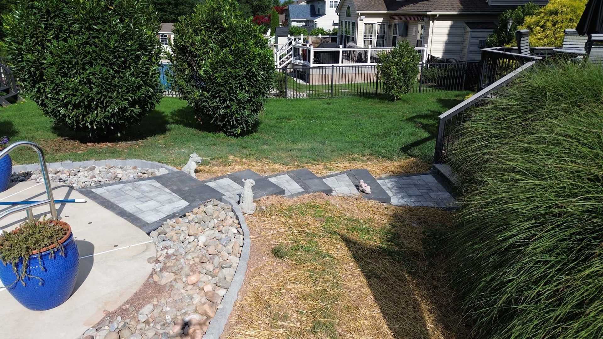 A patio area with a staircase leading up to a house.