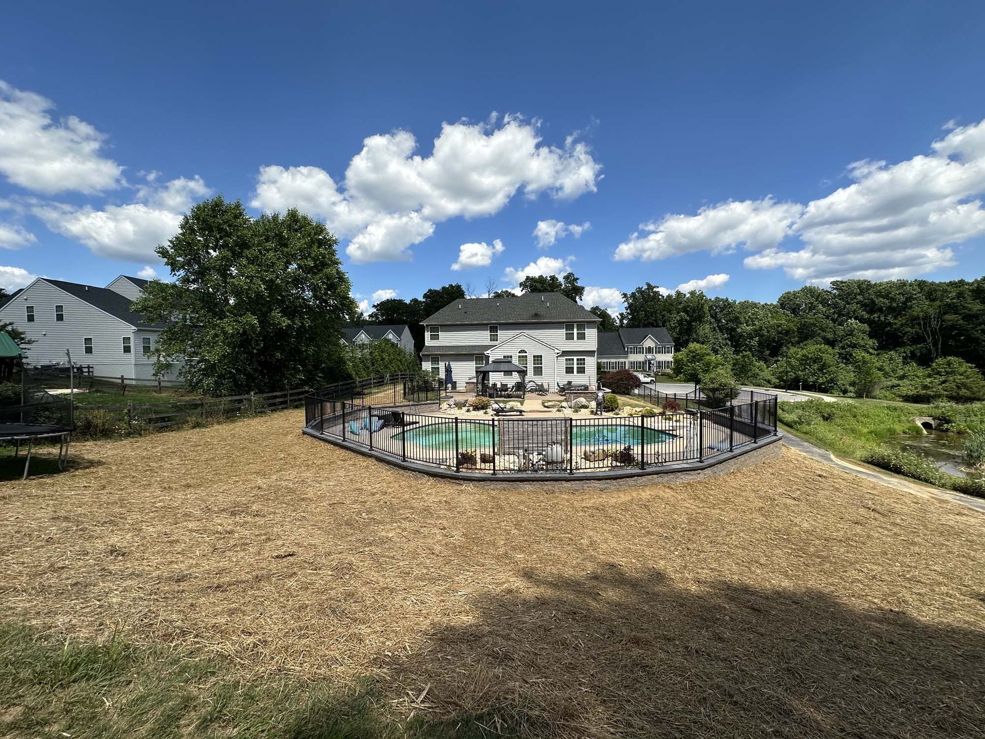 A large house with a swimming pool in the backyard
