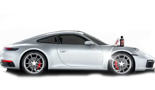 Silver Porsche car with a bottle of car cleaning product on the hood.