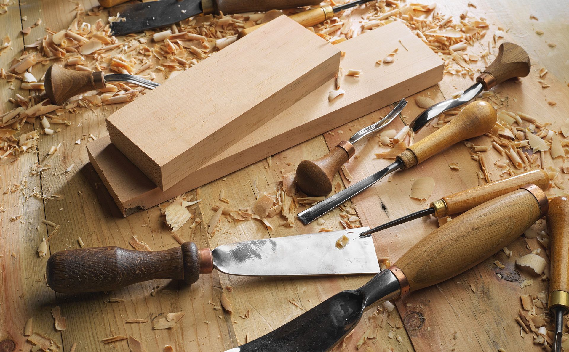 A wooden table with tools and a piece of wood on it
