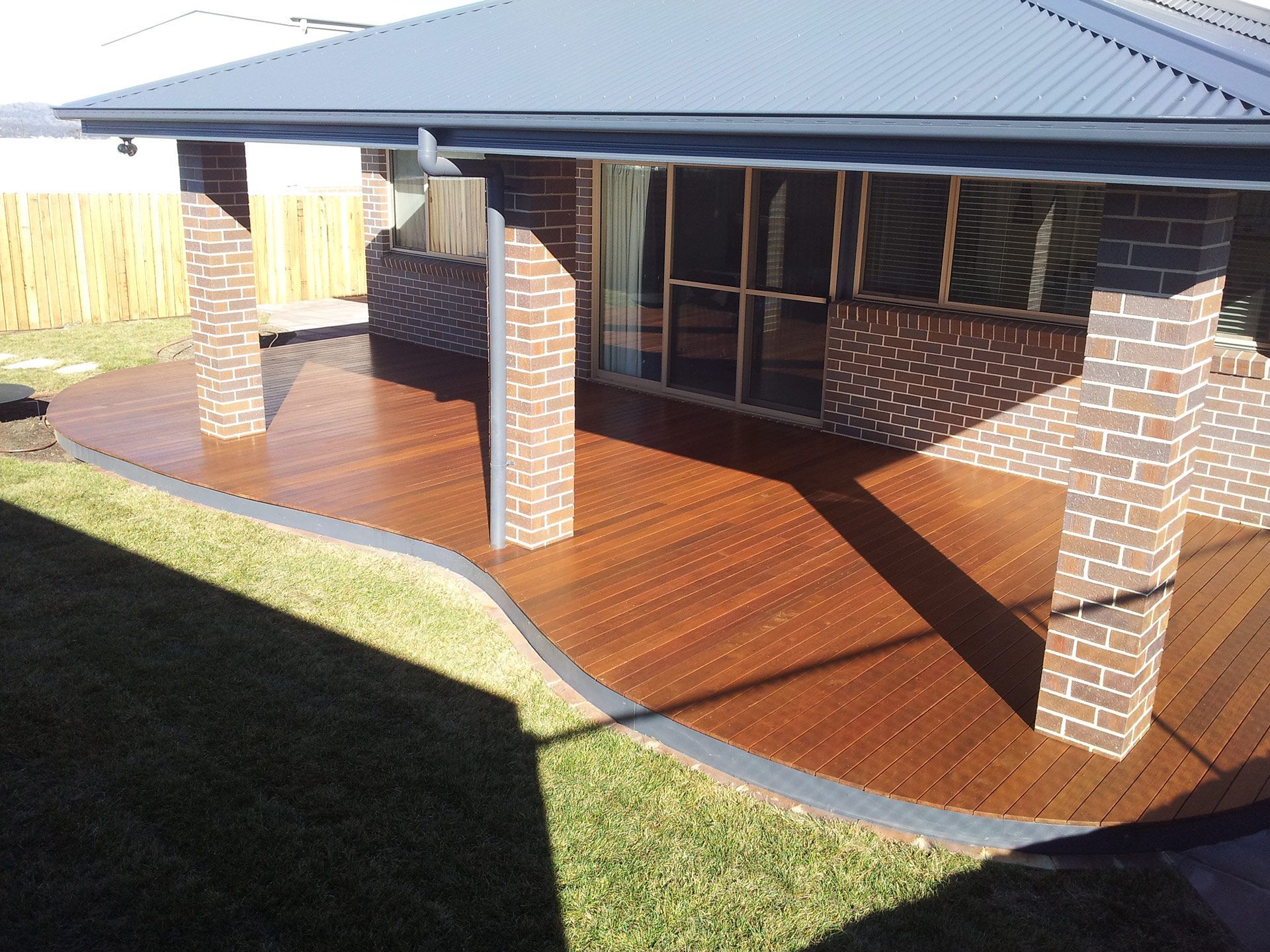 A brick house with a wooden deck in front of it