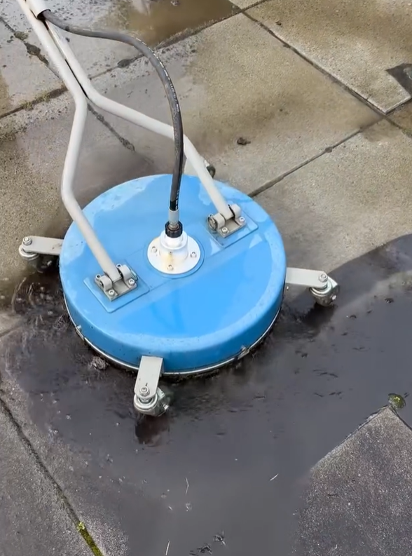 A blue and white machine is sitting on a sidewalk