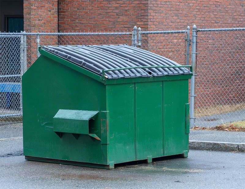 Christmas decorations are hanging from a tree at night.