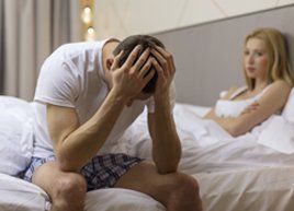 Testosterone Treatment — Man having a headache sitting on the bed with his wife in Baytown, TX