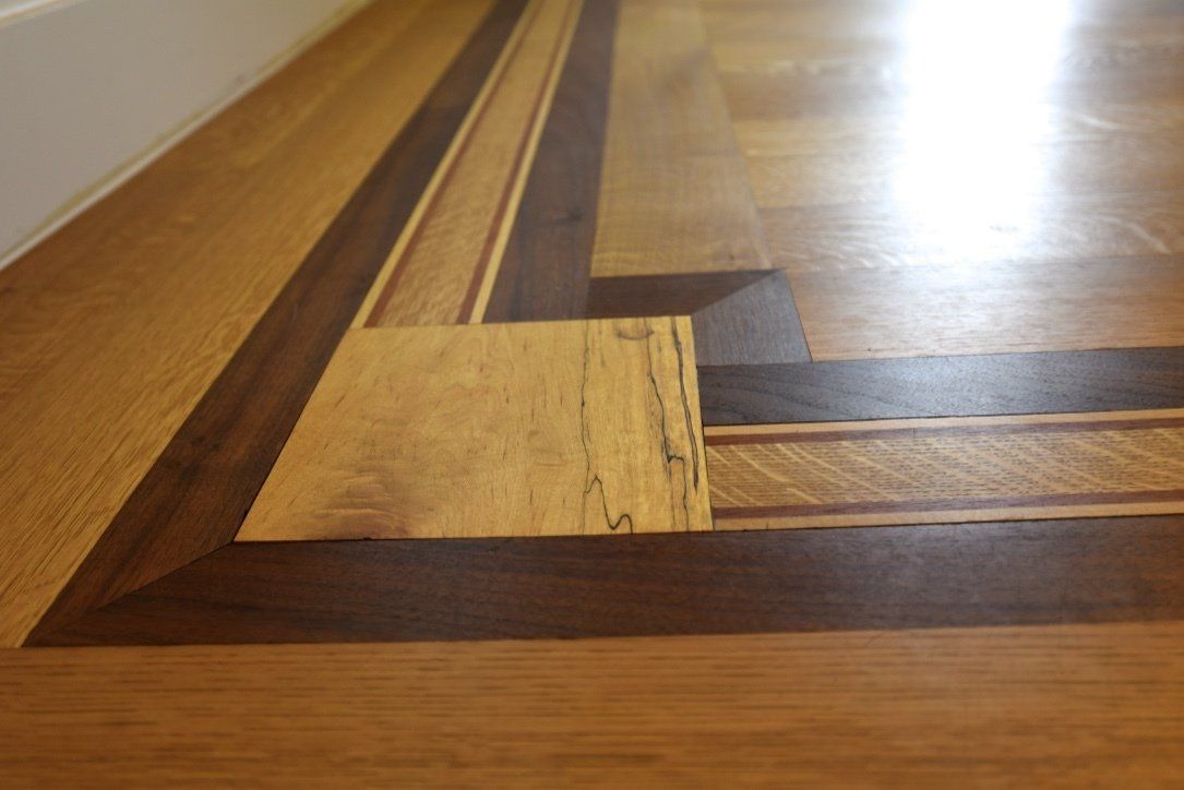 A close up of a wooden floor with a wooden border