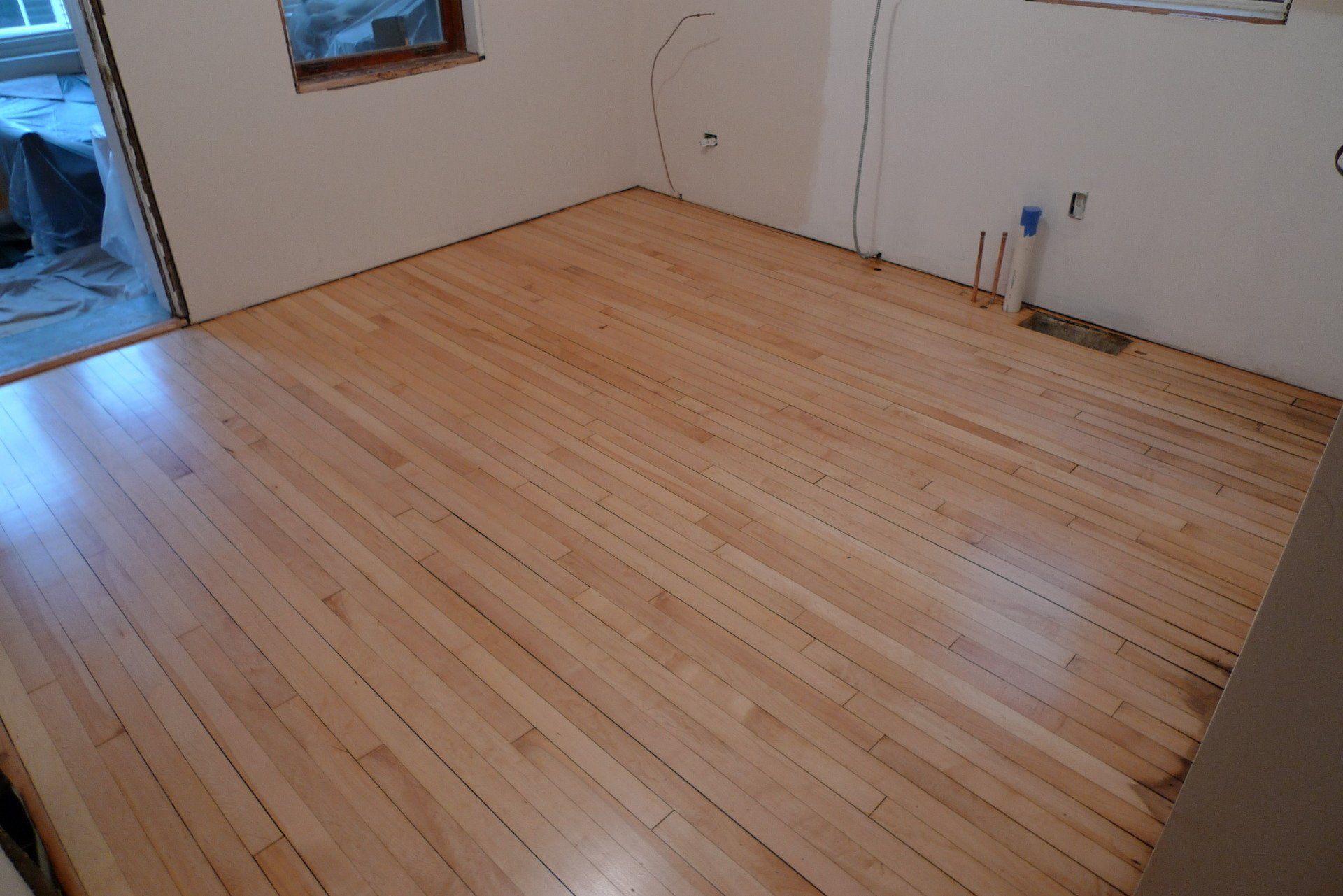 A room with a wooden floor and white walls