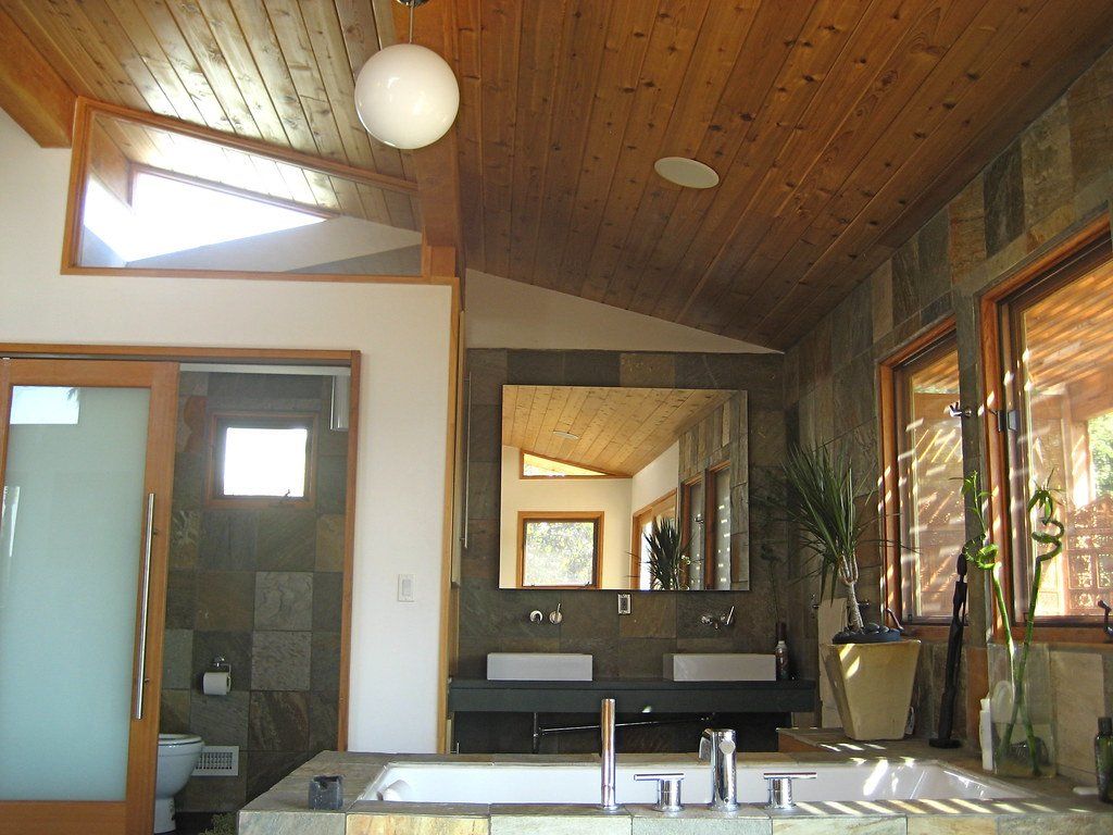 A bathroom with two sinks and a large mirror