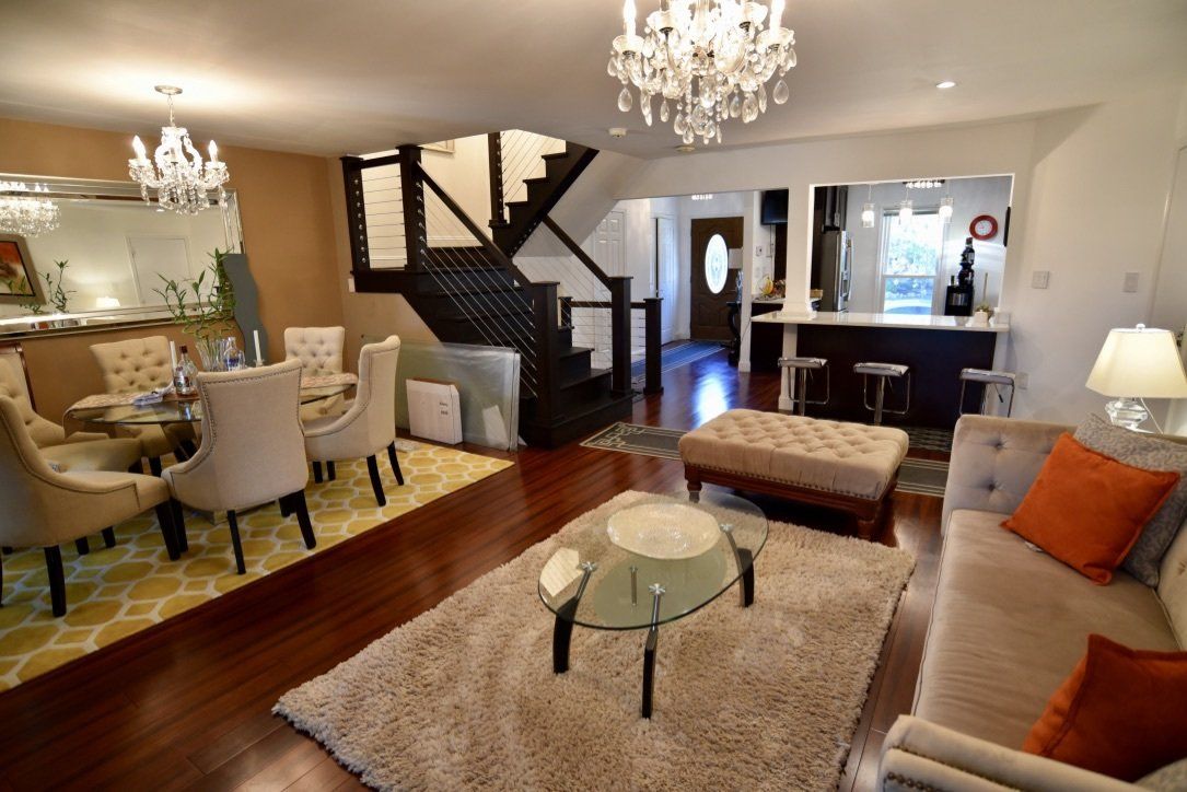 A living room filled with furniture and a staircase