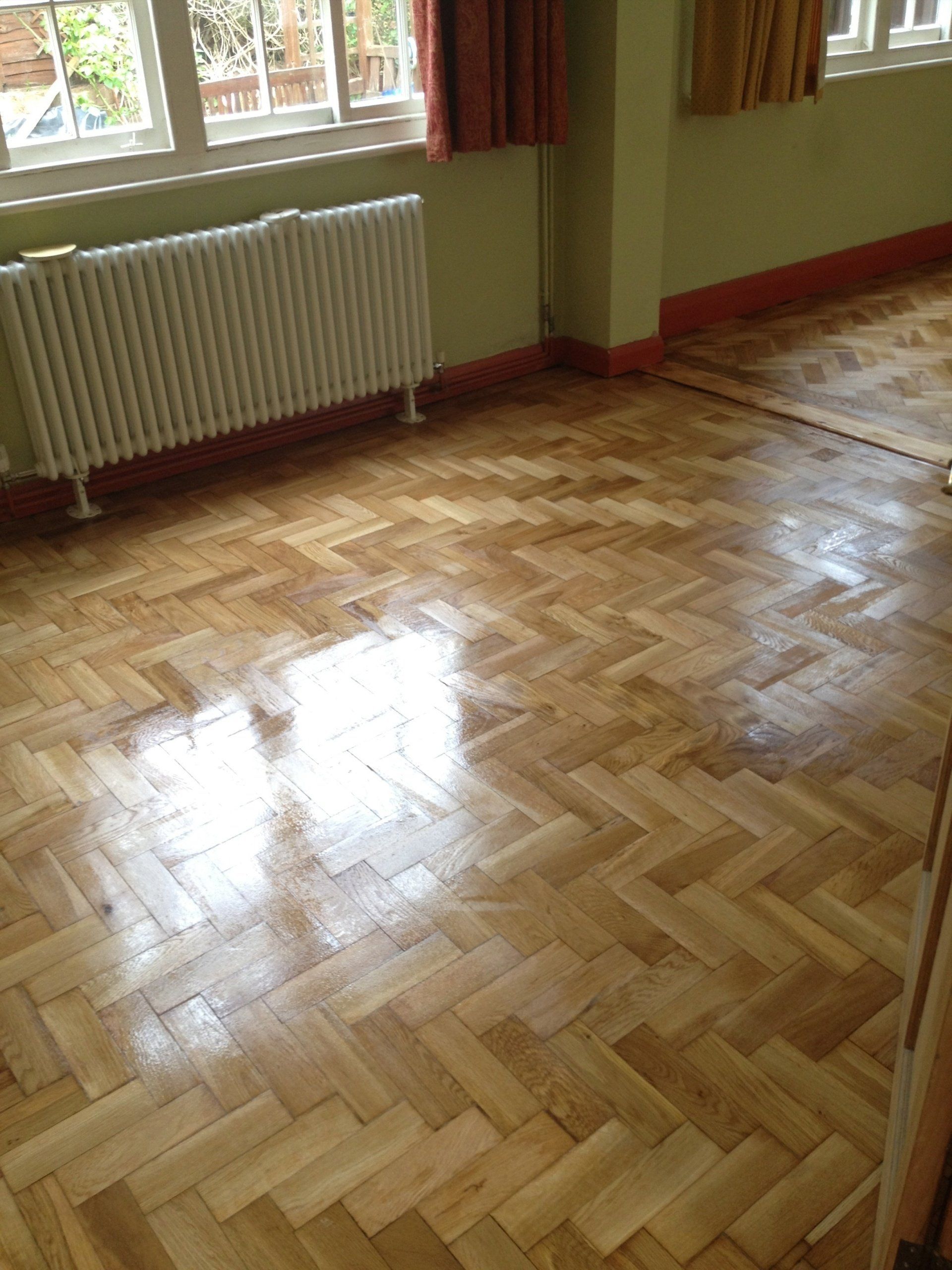 A room with a wooden floor and a radiator