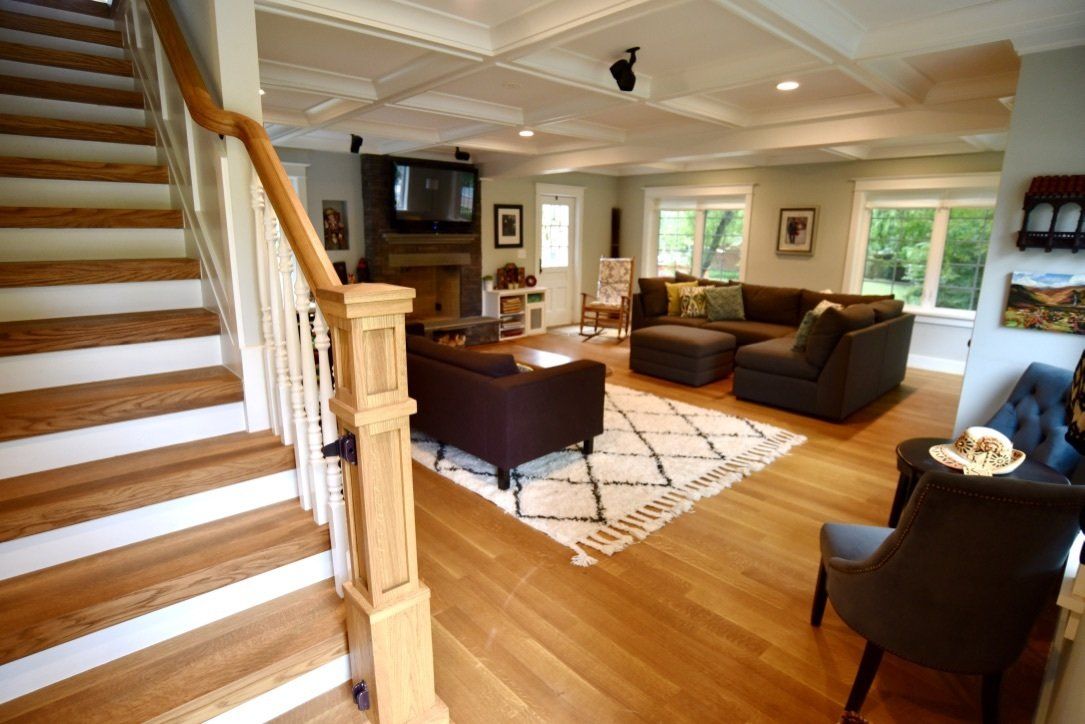 A living room with stairs leading up to the second floor