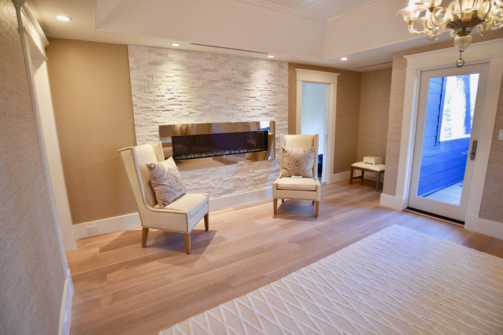 A living room with two chairs and a fireplace