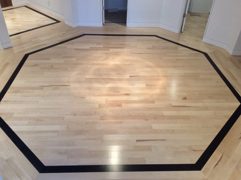 A wooden floor with a black circle in the middle