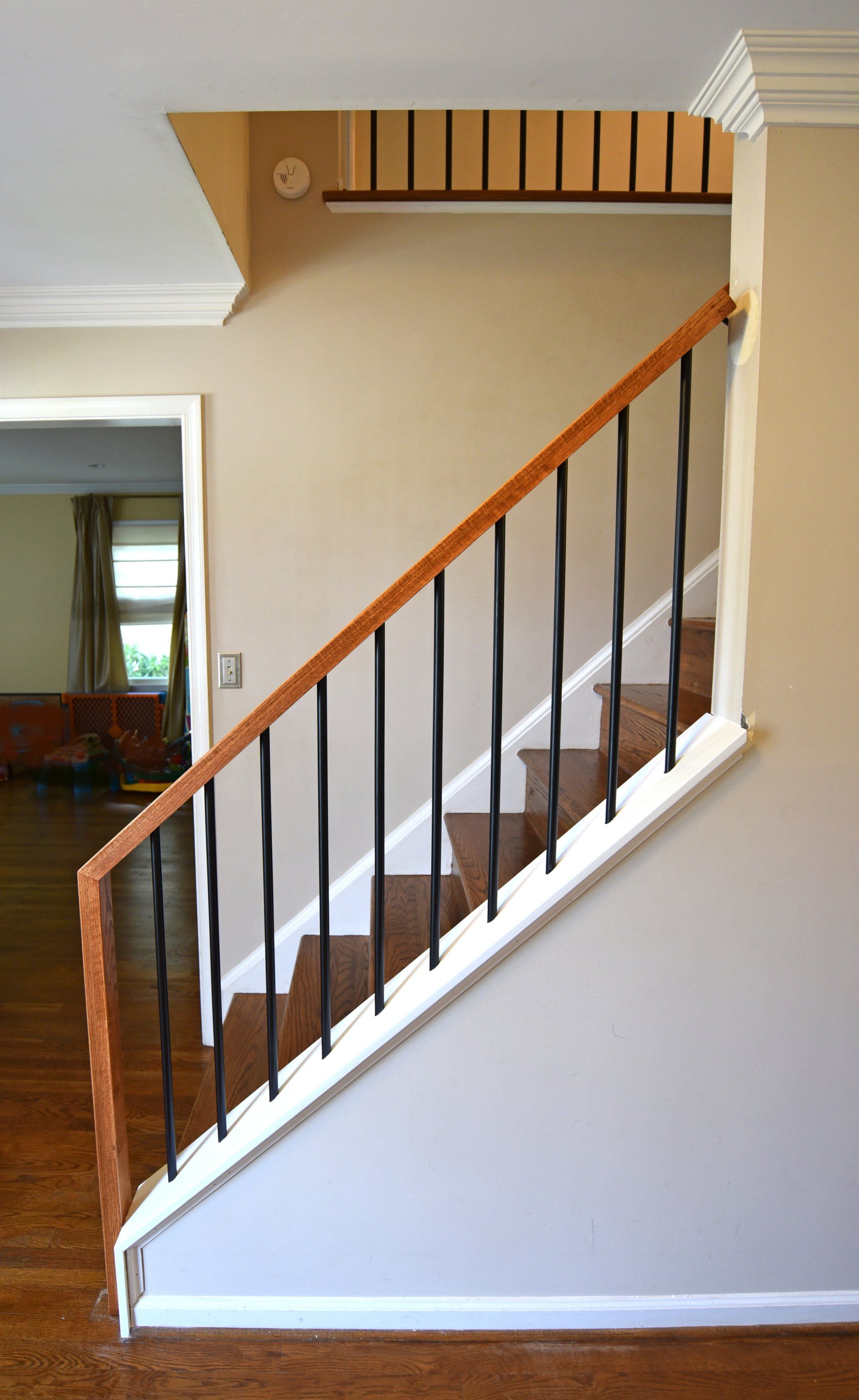 A staircase with a wooden railing and a metal railing