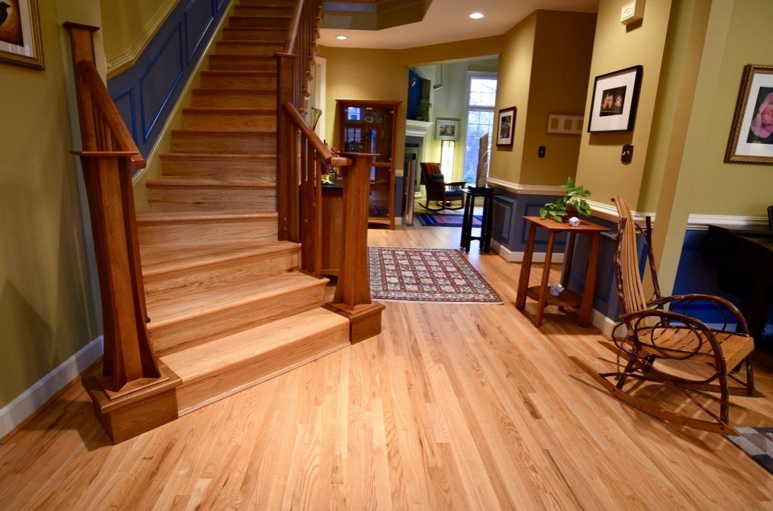 A wooden staircase in a house with a rocking chair