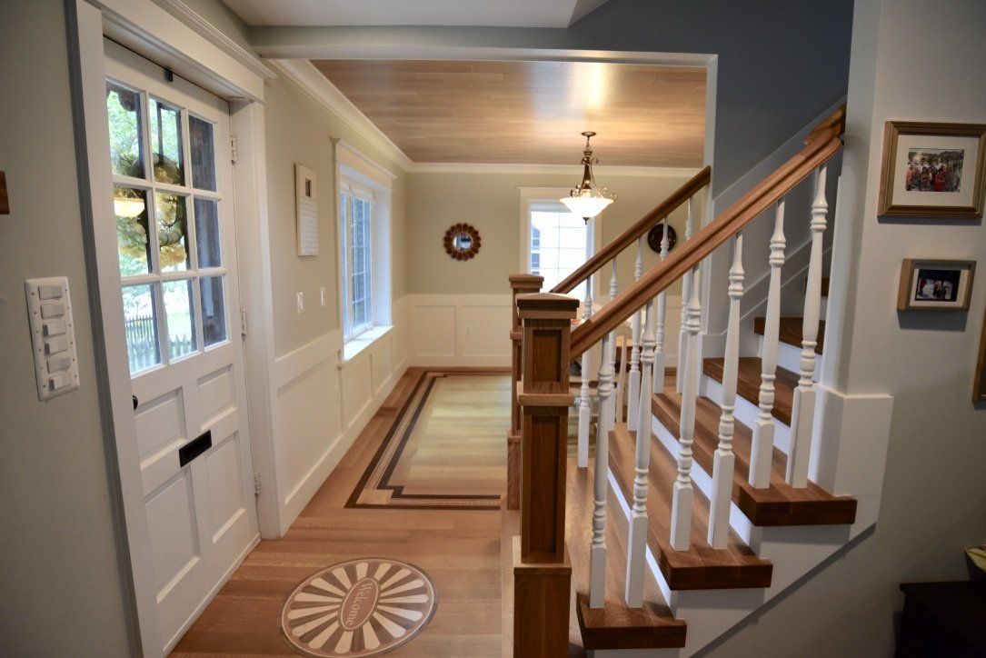 A hallway with stairs leading up to the second floor
