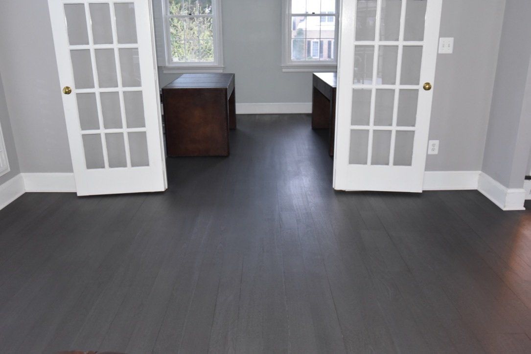 An empty room with french doors and a window