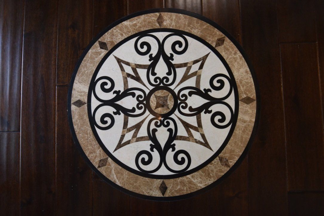 A wooden floor with a circular design on it