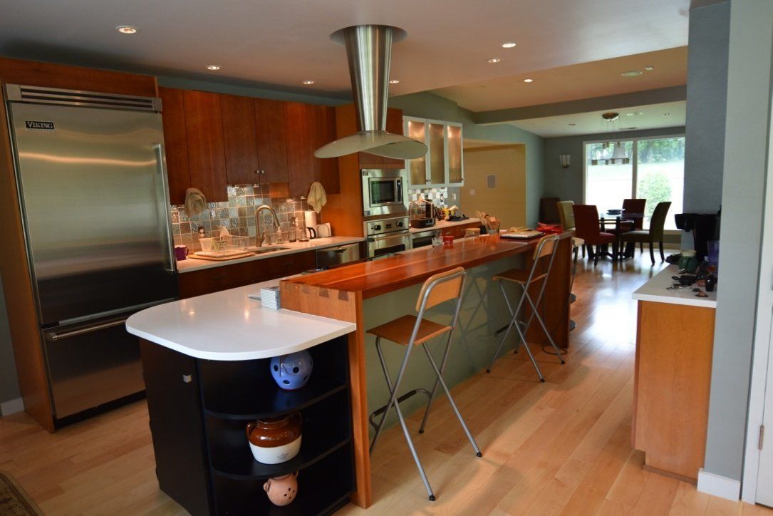 A kitchen with stainless steel appliances and a large island