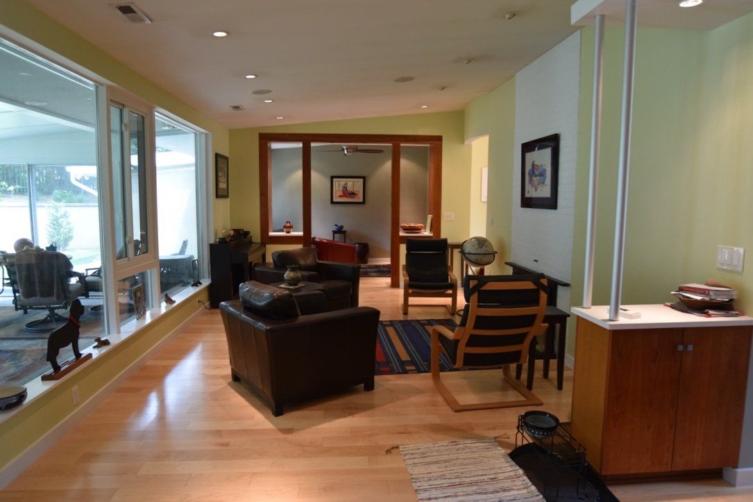 A living room with a lot of furniture and windows