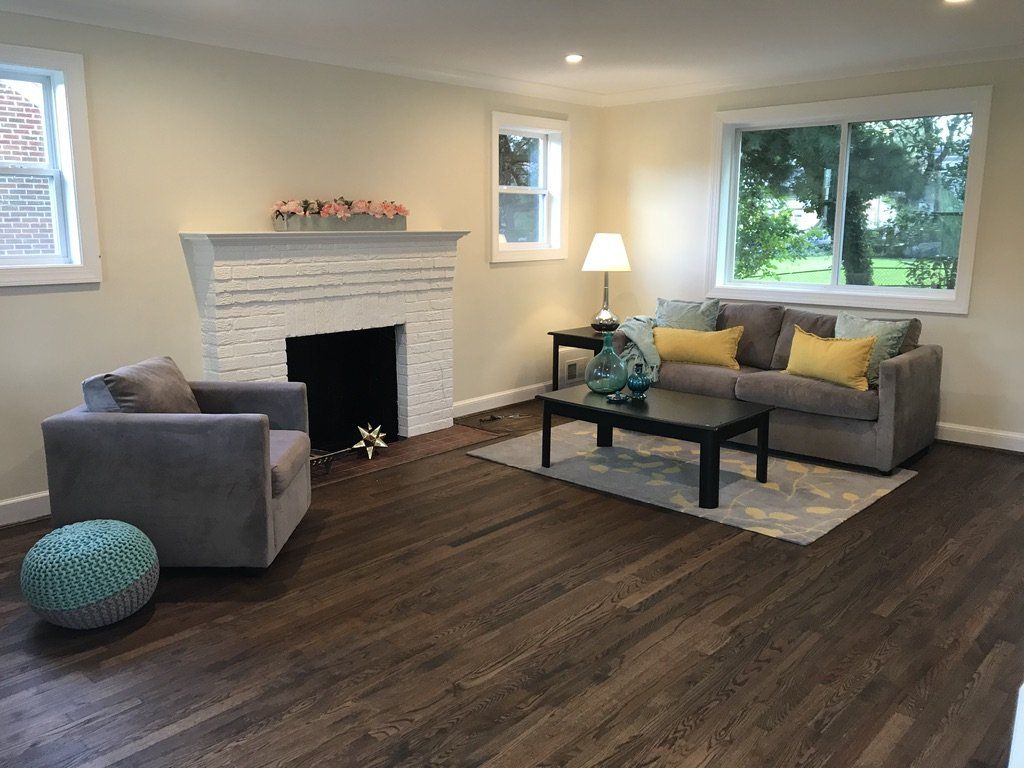 A living room with a couch a chair and a fireplace