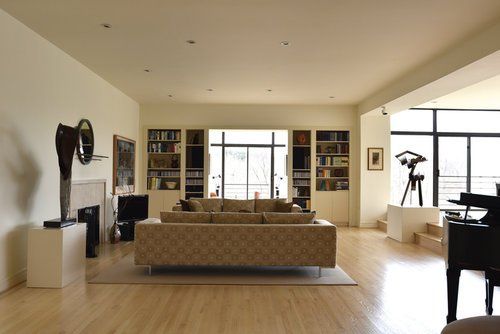 A living room with a couch and a piano