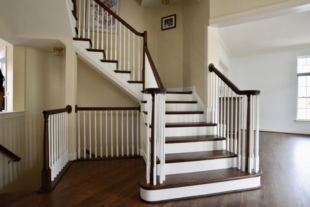 A staircase with white railings and wooden steps