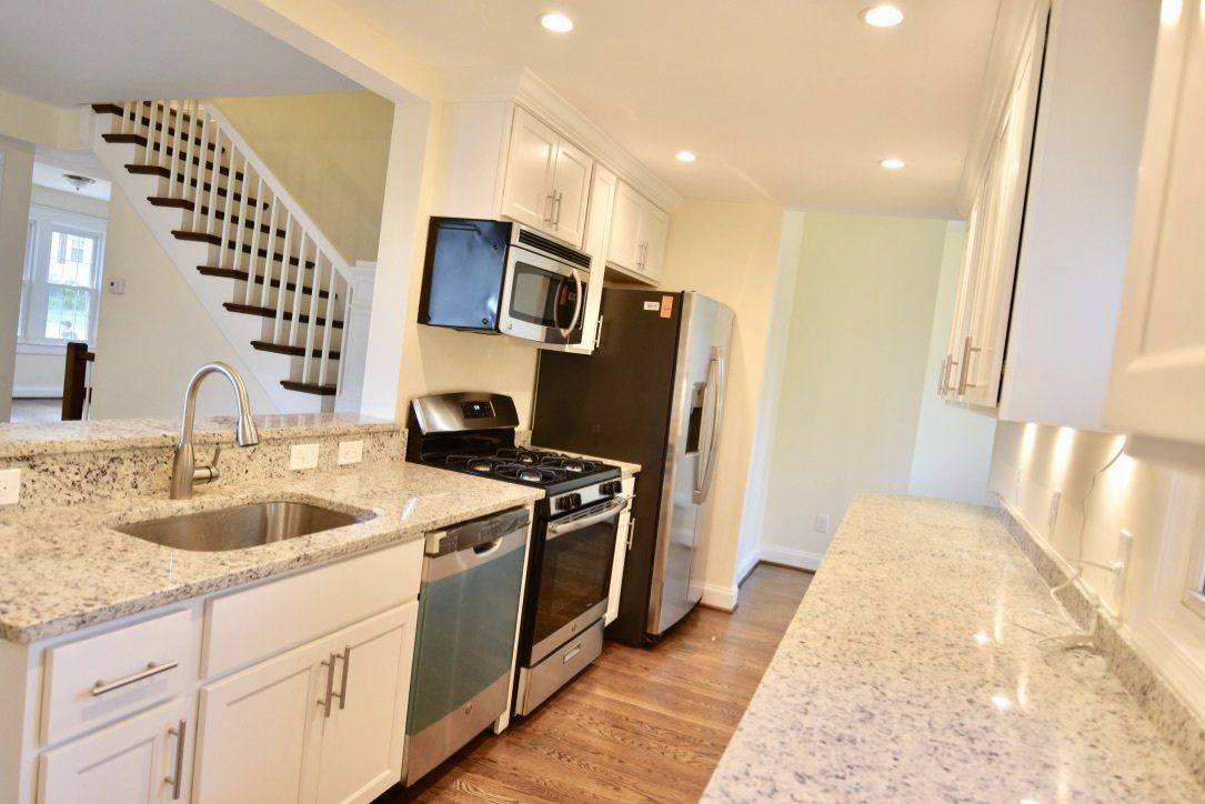 A kitchen with stainless steel appliances and granite counter tops