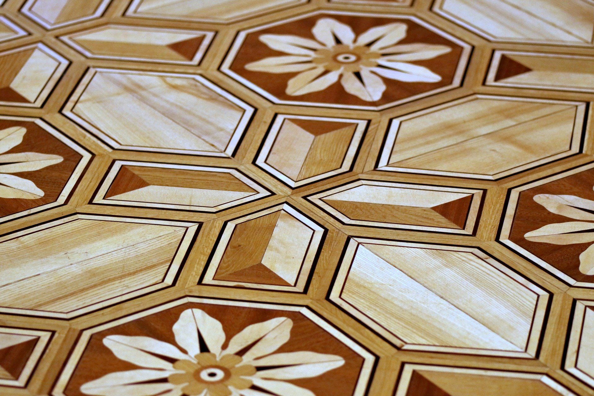 A wooden floor with a flower design on it
