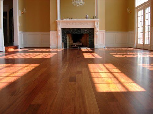 A living room with hardwood floors and a fireplace
