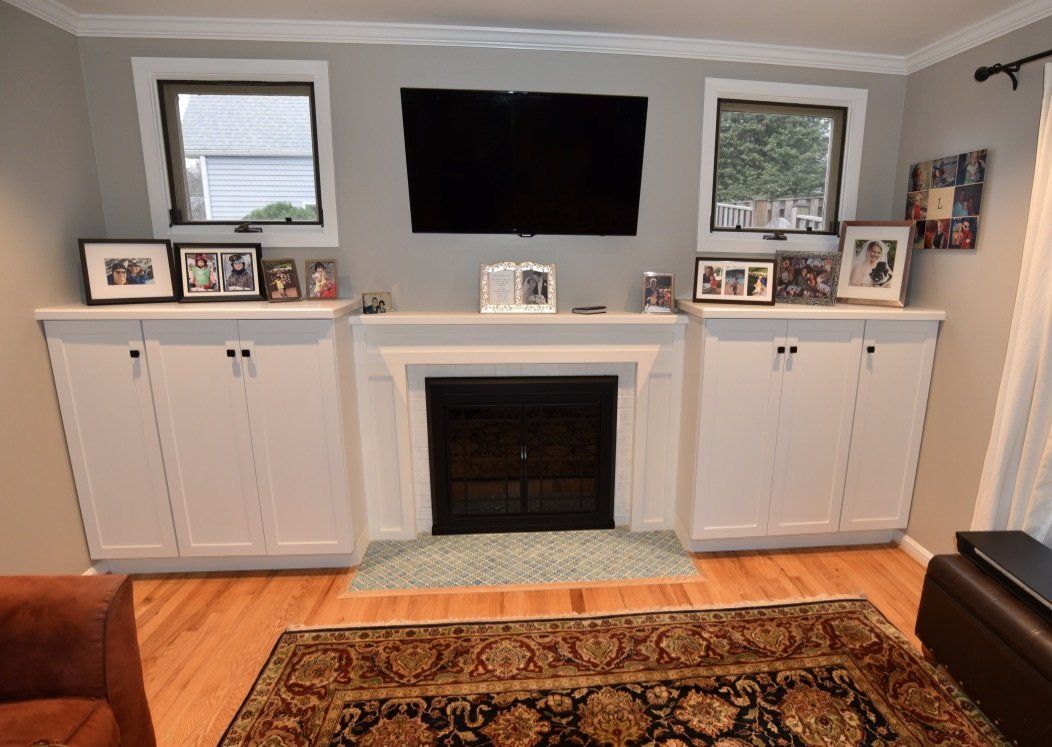 A living room with a fireplace and a flat screen tv