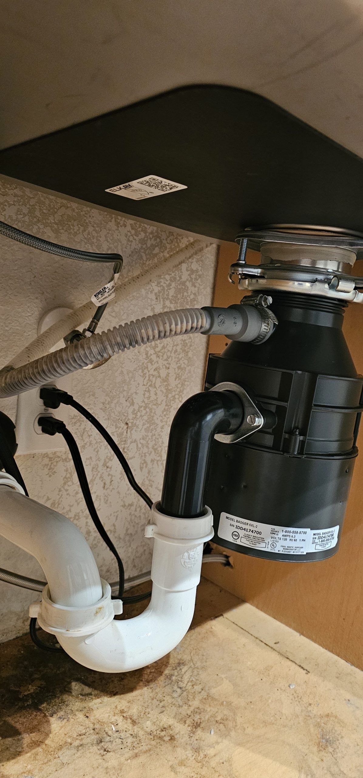 A sink with a garbage disposal attached to it.