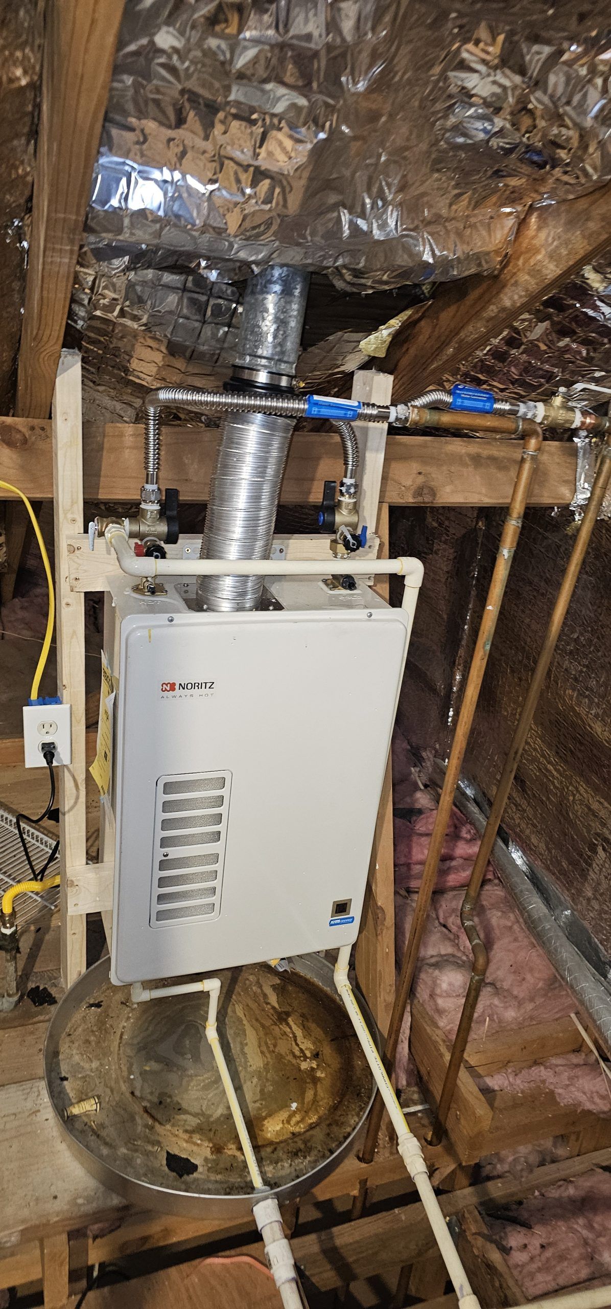 A water heater is installed in the attic of a house.