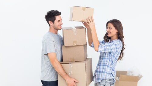 Men and Women Lifting Boxes — Storage Units in La Pine, OR Men and Women Lifting Boxes — Storage Units in La Pine, OR