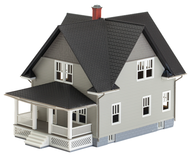 A model house with a black roof and a porch