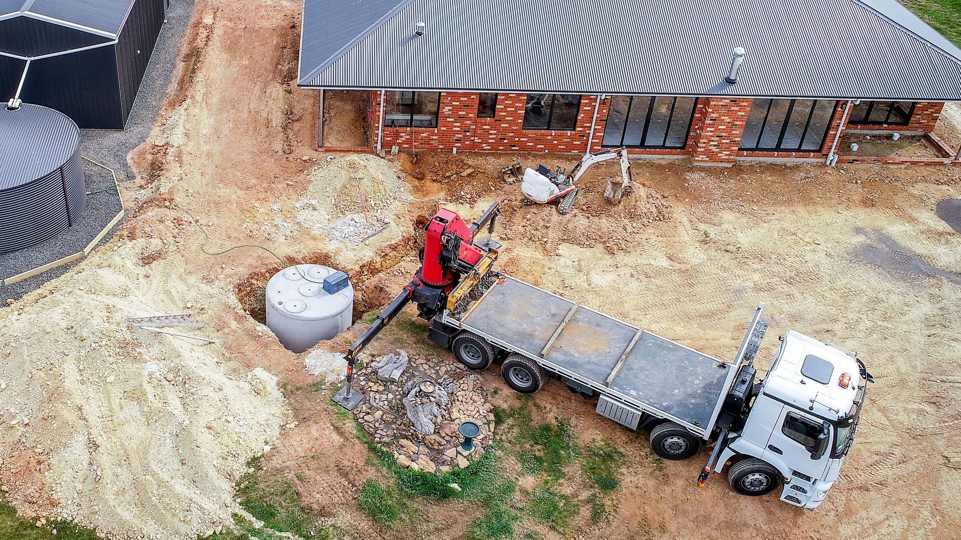 An aerial view of a construction site with a truck and a crane.