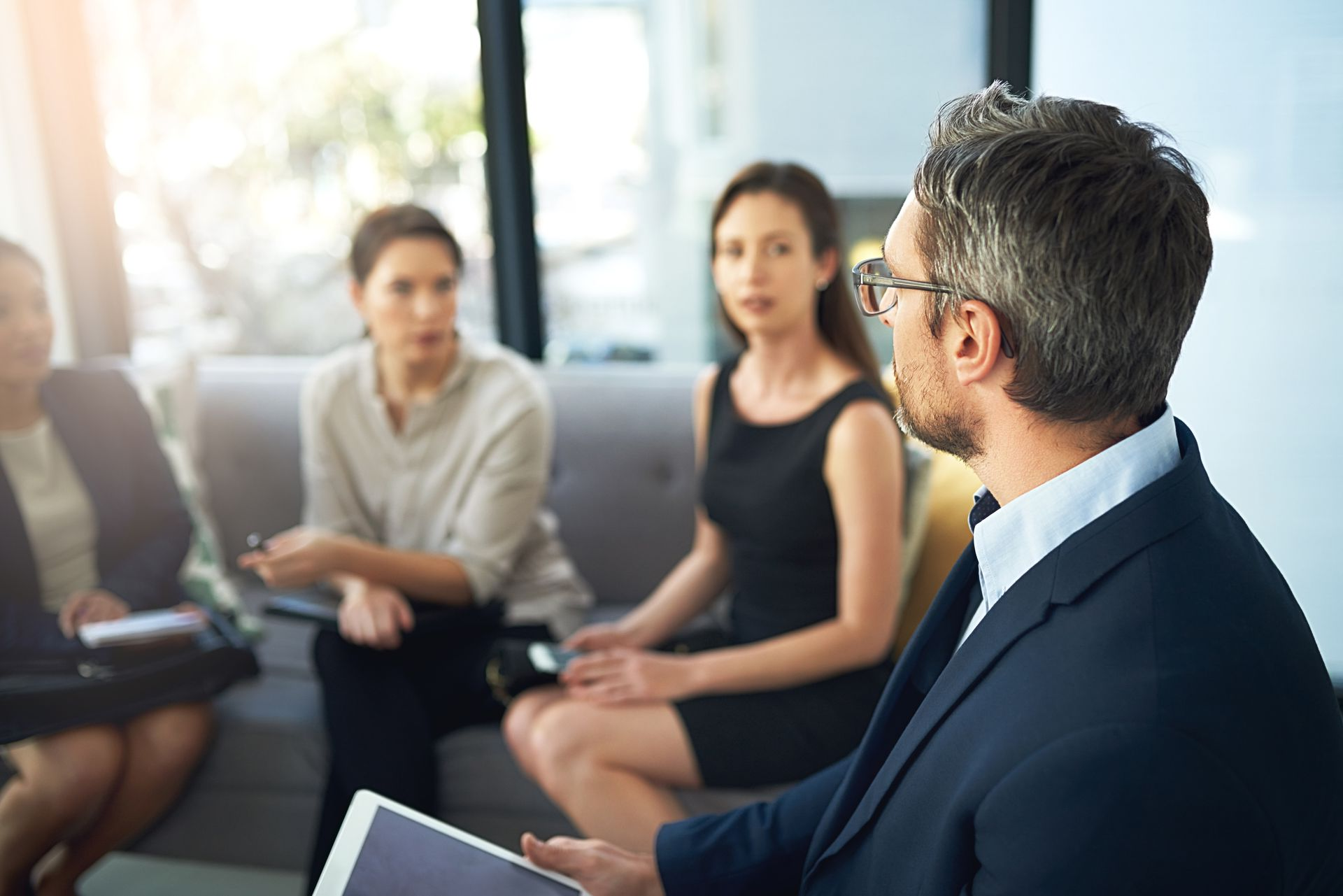 Two men in suits and ties are looking at a computer screen.