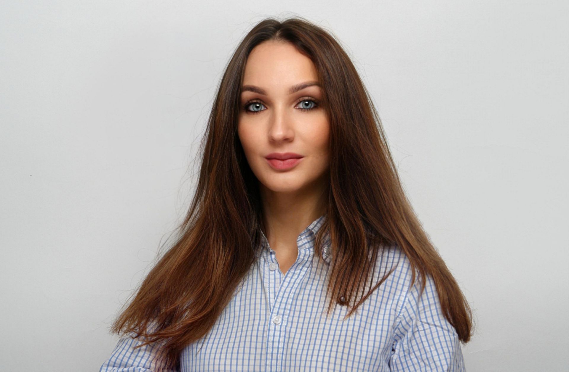 A man in a plaid shirt is smiling for the camera.