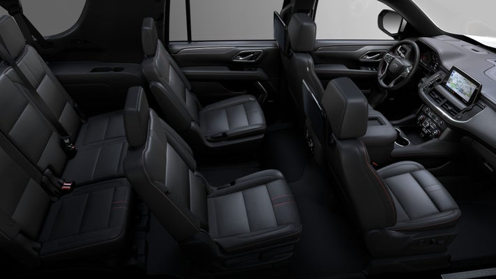 Interior view of a black SUV showing the driver's area and rows of black leather seats.