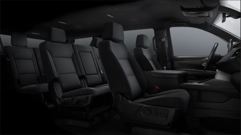 Black interior of a vehicle with dark gray seats and a center console.