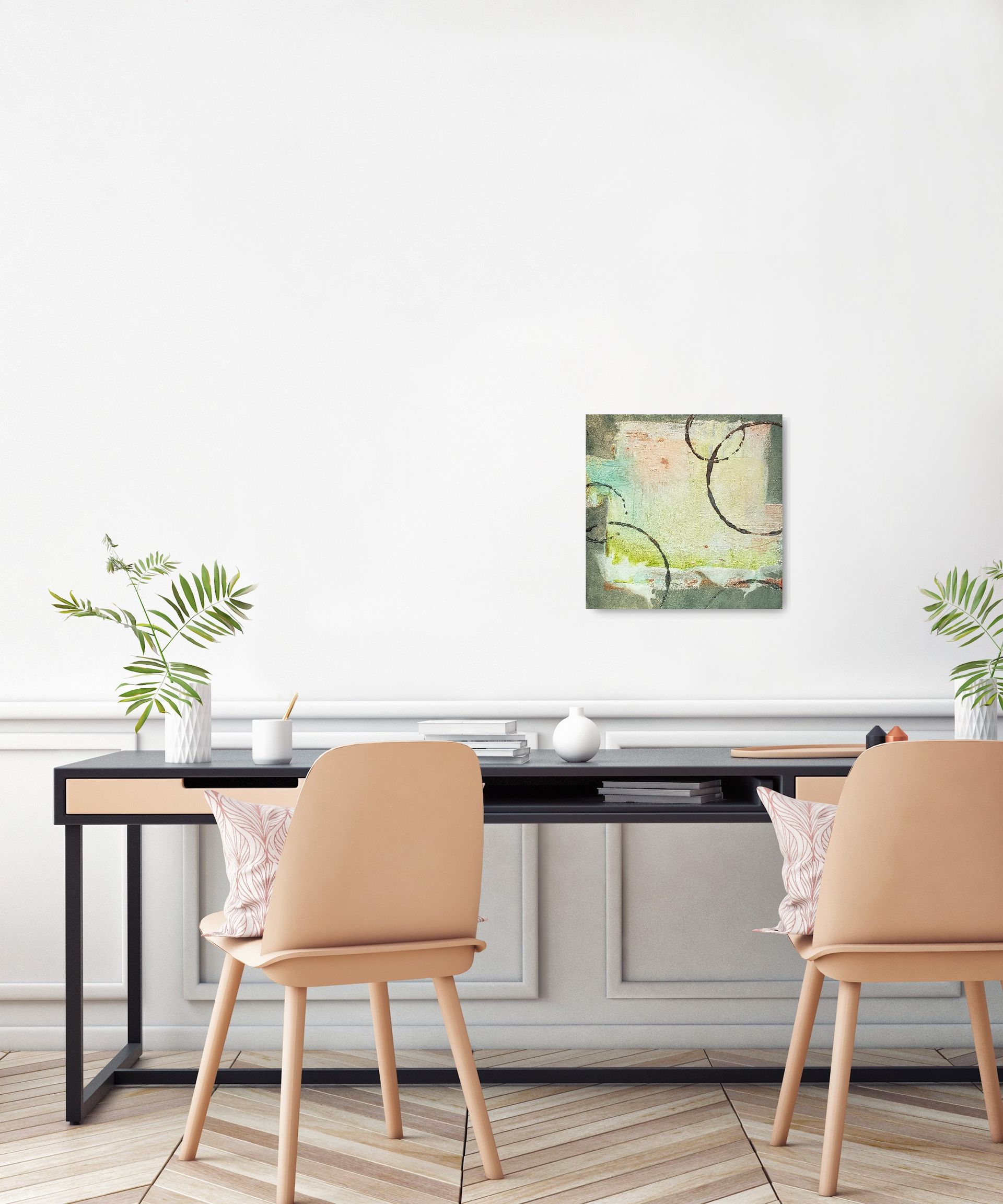 A desk with two chairs and a painting on the wall above it