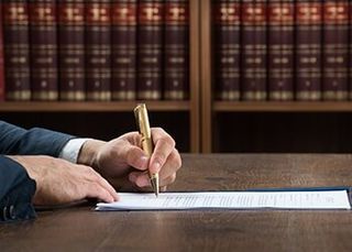 Lawyer Writing on Legal Documents — Estate Planning in Sacramento, CA