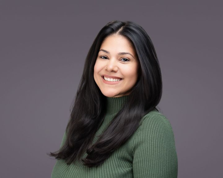 Professional business headshot of a female executive in Dallas office setting
