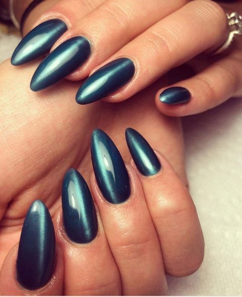 A close up of a woman 's nails with blue polish
