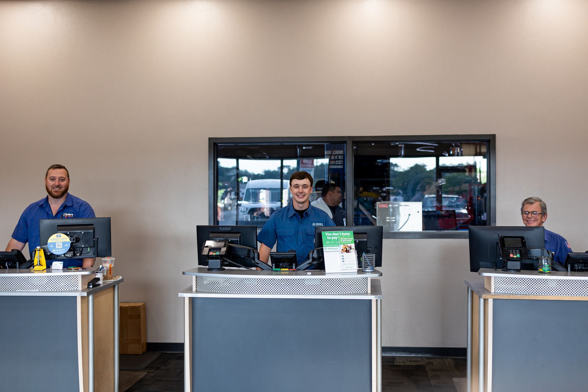 Employees Behind Service Counters | Parker's Tire & Auto Service