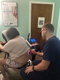 A woman is getting a massage from a female doctor.